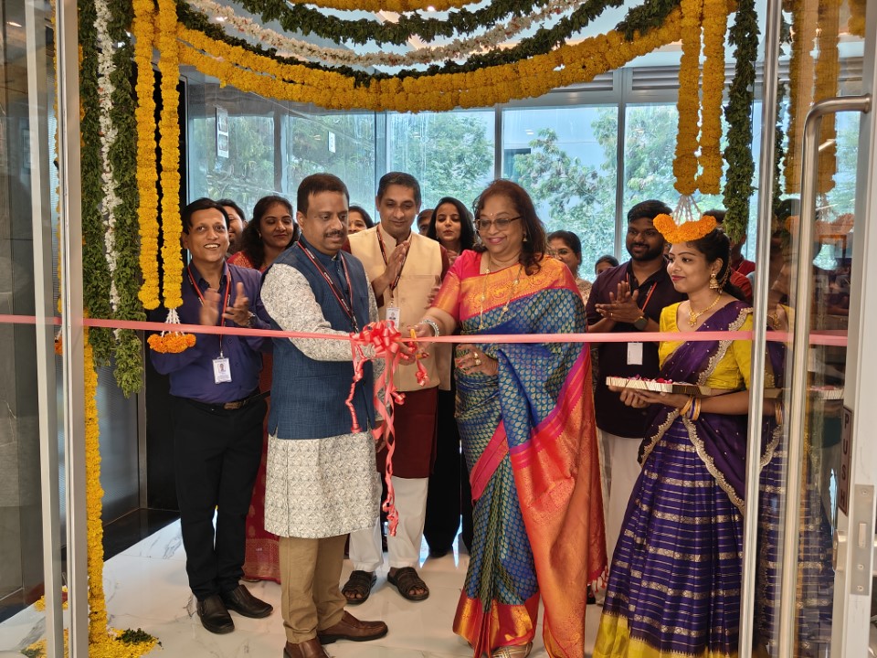 Exostar India employees cutting the ribbon on the new offices there.