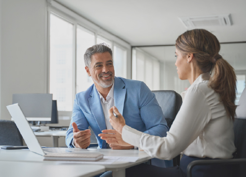 A man and a woman talking about careers at Exostar in Australia.