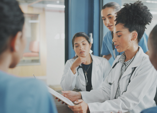 Four healthcare workers having a conference and looking at data.