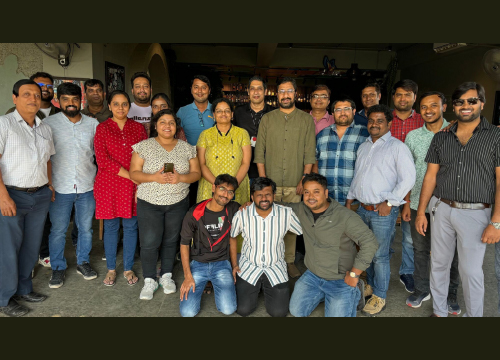 A group of employees team building at Exostar India.