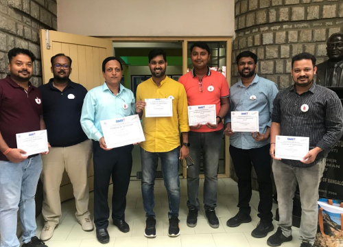 Seven employees from Exostar India showing their volunteer opportunities.